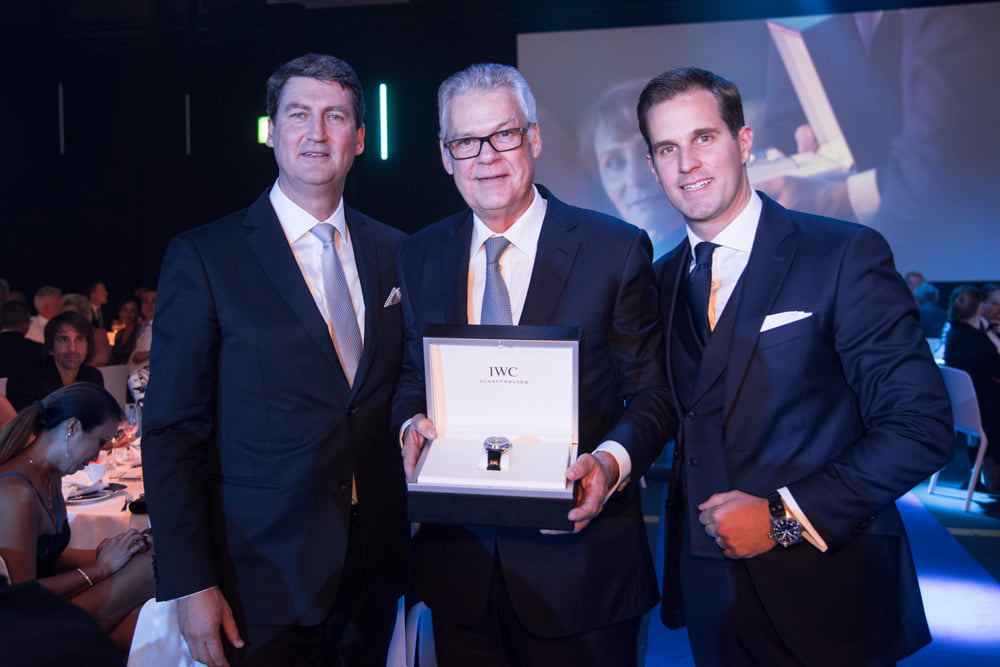 Managing Director IWC Switzerland Linus Fuchs (L) and CEO IWC Schaffhausen Christoph Grainger-Herr (R) hand over the auctioned watch to the highest bidder during the 11th Laureus Charity. The IWC Portugieser Tourbillon Retrogarde Chronograph Edition 'Laureus Sport for Good Foundation' was auctioned for CHF 200 000.